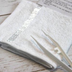 Cold or hot towel set in tray with tweezers